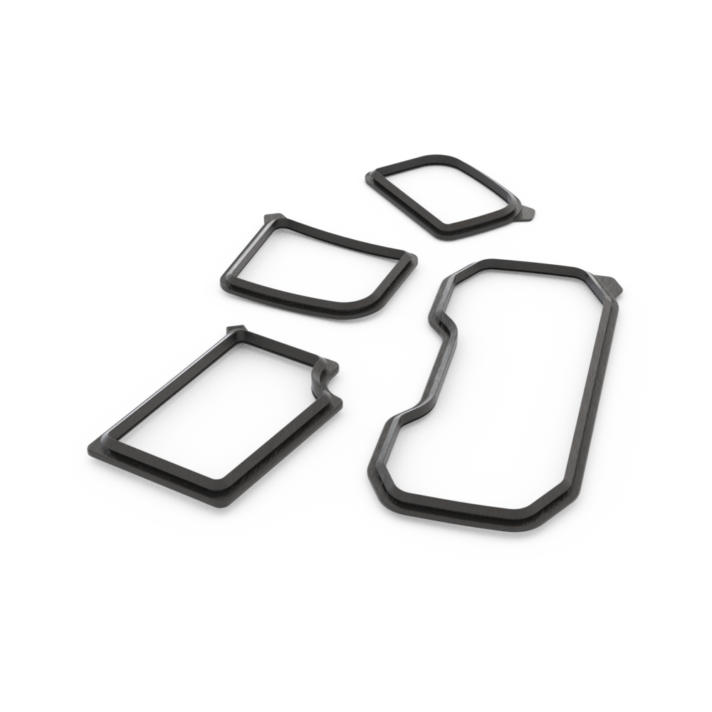 A collection of black window trim seals of various shapes displayed on a white background.