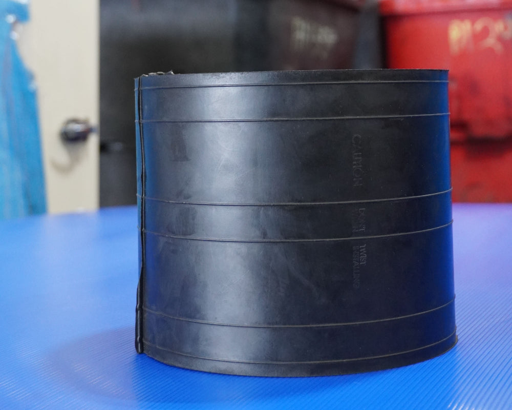 Stack of black neoprene sleeve on a blue surface with a blurred background